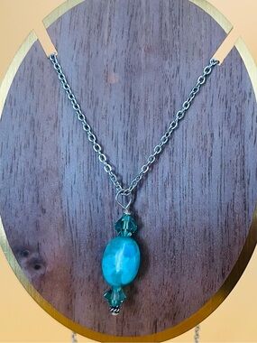 Oval turquoise & crystals pendant set in silver plus a stainless steel necklace